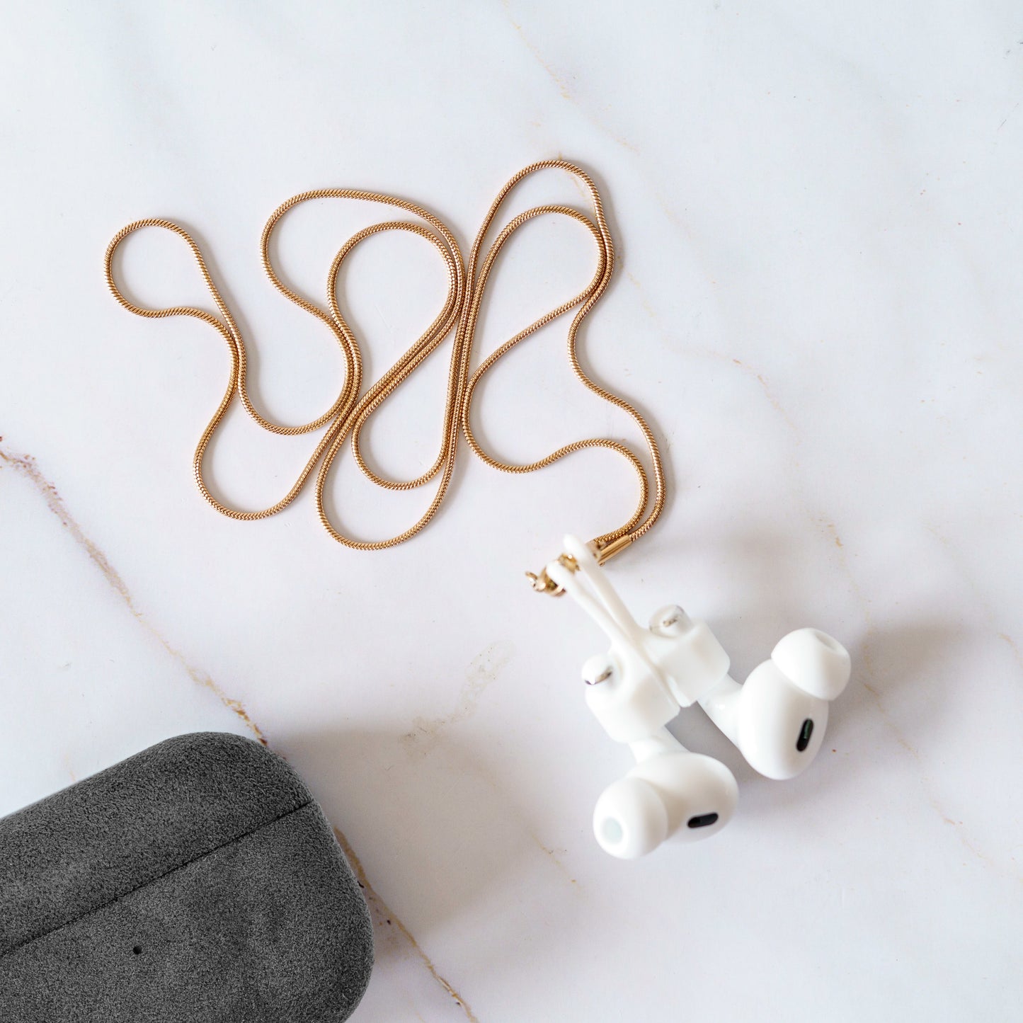 AirPods Alcantara case with necklace in lifestyle use