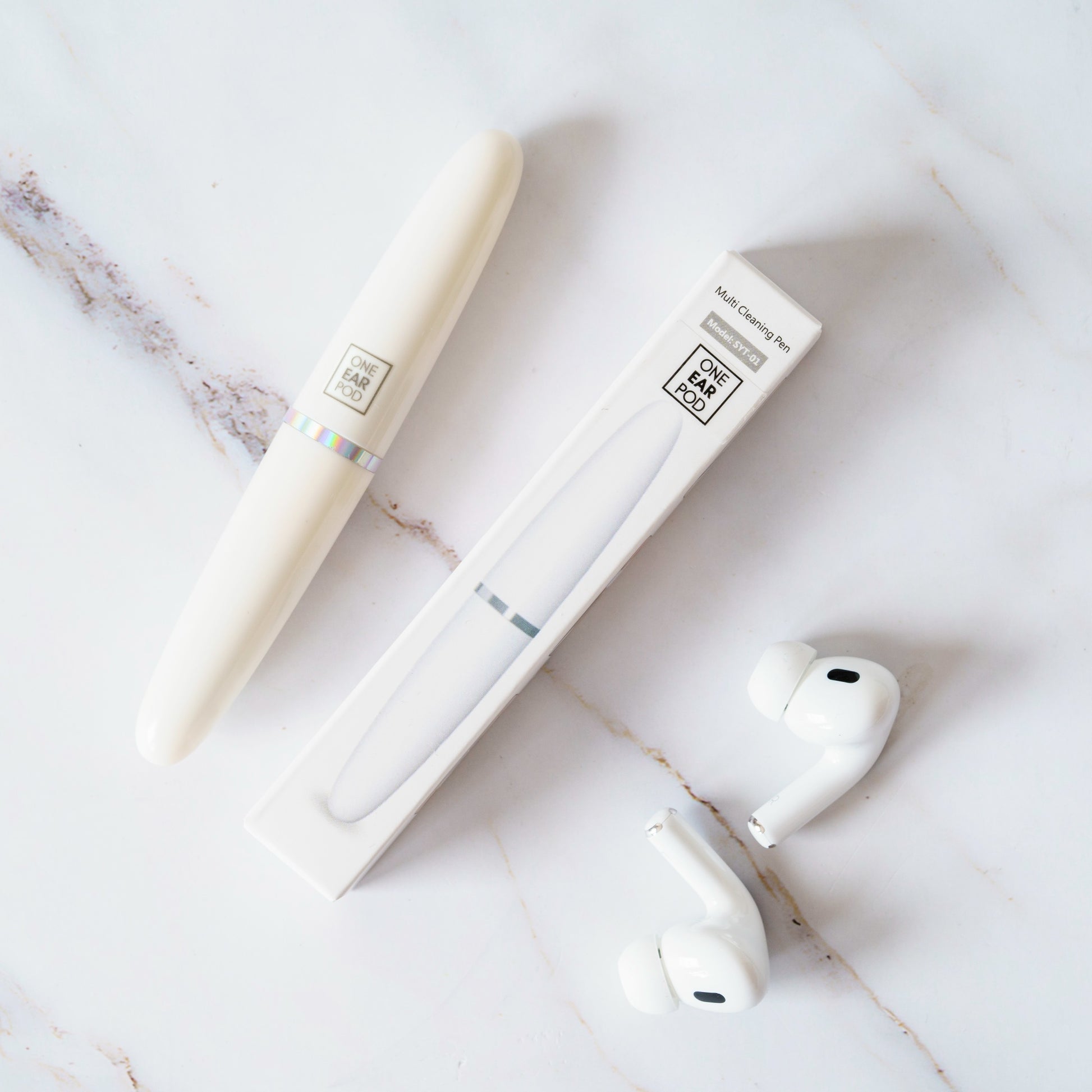 AirPods cleaning tool in use on earbud mesh